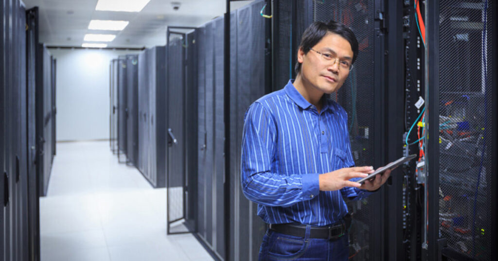 IT network administrator in a server room.