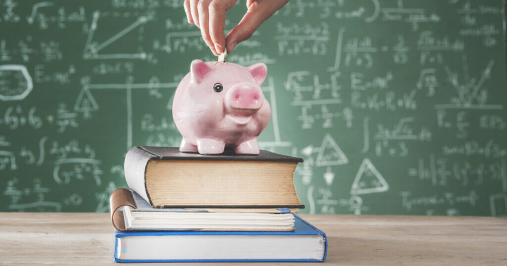 Female putting coin into piggy bank