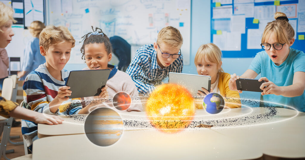 Group of School Children in Science Class Use Digital Tablet Computers with Augmented Reality Software, Looking at Educational 3D Animation Of Solar System. VFX, Special Effects Render